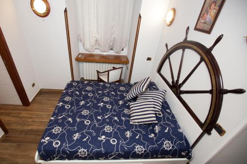 a bedroom with a bed with a blue and white comforter at Hotel Ausonia in Naples