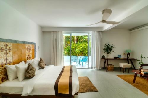 a bedroom with a large bed and a balcony at Naiya Sea Resort in Sihanoukville