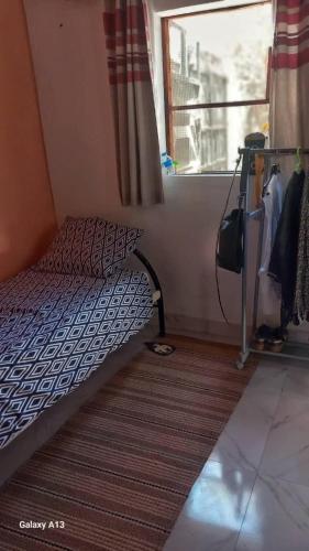 a bed in a room with a window at Arijaana Guest Studio in Gunjur