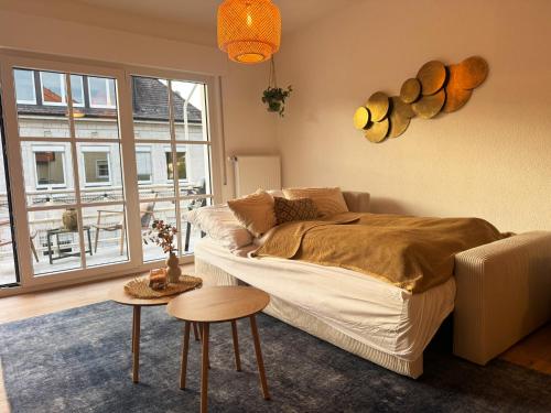 a bedroom with a bed and a couch and a window at MurgLoge Gaggenau in Gaggenau