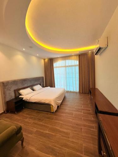 a bedroom with a bed and a large window at فلة درة العروس in Jeddah