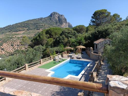 a swimming pool with a mountain in the background at Villa Jael in El Gastor