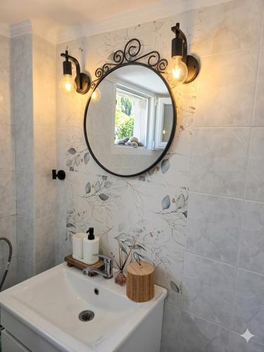 a bathroom with a sink and a mirror at Dimi Guest House in Perea