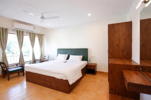a bedroom with a large bed and a large window at Hotel Maharaja in Rewa