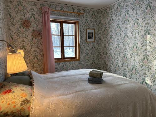 a bedroom with a bed with a teddy bear on it at Sunshine Stuga Mörtsjön in Stugun
