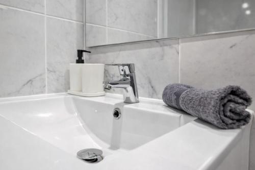 a bathroom with a sink with a towel on it at Ocean View Ponderosa 601 Costa Adeje Playa de las Americas in Costa de Adeje