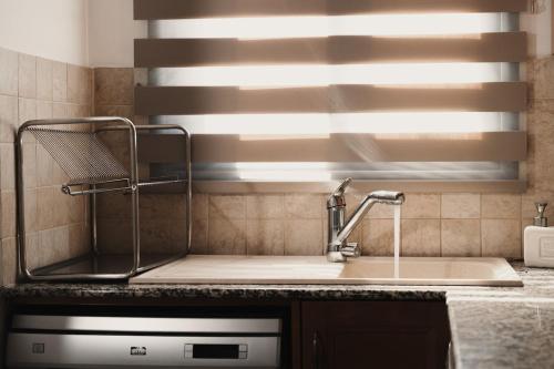 a kitchen counter with a sink and a window at Toma Villa in Paralimni