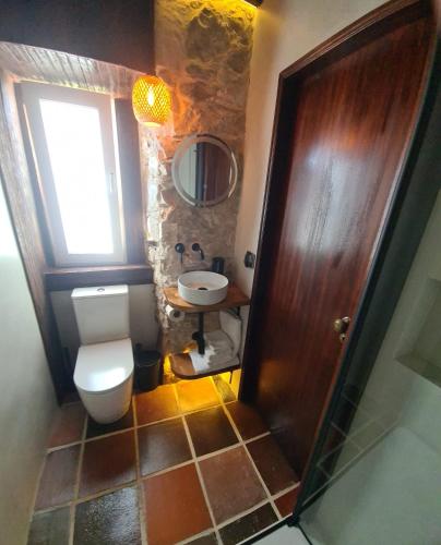 a bathroom with a toilet and a sink at Casa das Marés 3 in Baleal