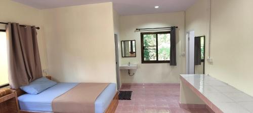 a bedroom with a bed and a sink and a mirror at Happy Bungalow in Ko Tao