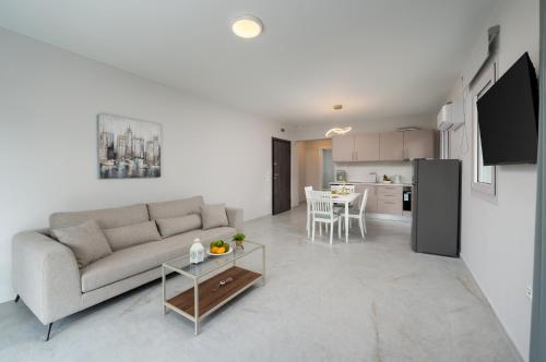 a living room with a couch and a table at Kamara View Apt 1 in Agios Nikolaos