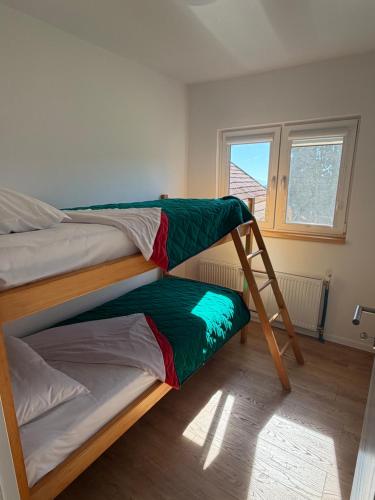 two bunk beds in a room with a ladder at Travnik Nature in Travnik