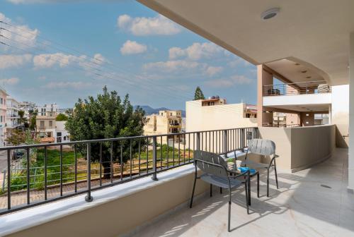 a balcony with two chairs and a view at Kamara View Apt 1 in Agios Nikolaos