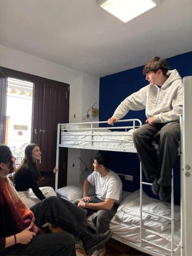 a group of people sitting on top of bunk beds at Oh! My Hostel in Granada