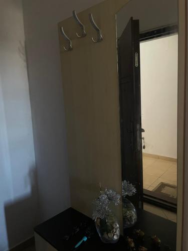 a bathroom with a mirror and a vase on a table at Sior in Golem