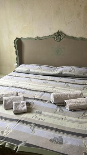 a bed with three pillows on top of it at Love Gioia Tauro in Gioia Tauro