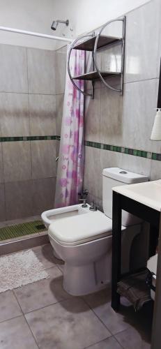 a bathroom with a toilet and a sink at LaChula Casa con Piscina in Federación