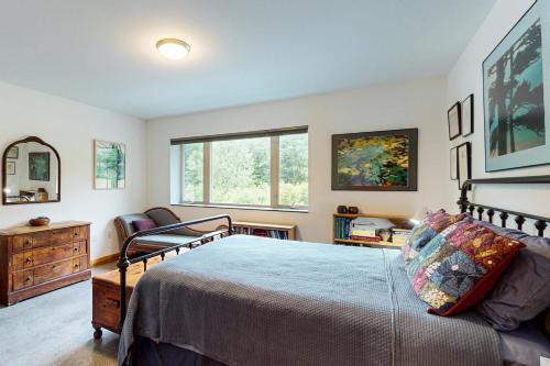 a bedroom with a bed and a chair and a window at Secluded 2 BR Cottage w/ Private W/D, WiFi & Patio in Franklin Road