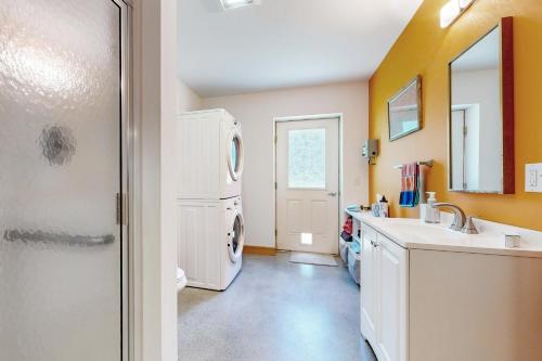 a laundry room with a washer and dryer in it at Secluded 2 BR Cottage w/ Private W/D, WiFi & Patio in Franklin Road