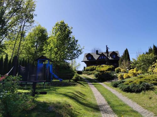 a garden with a house in the background at Agroturystyka Ranczo Turzyniec w pobliżu Zwierzyńca in Turzyniec