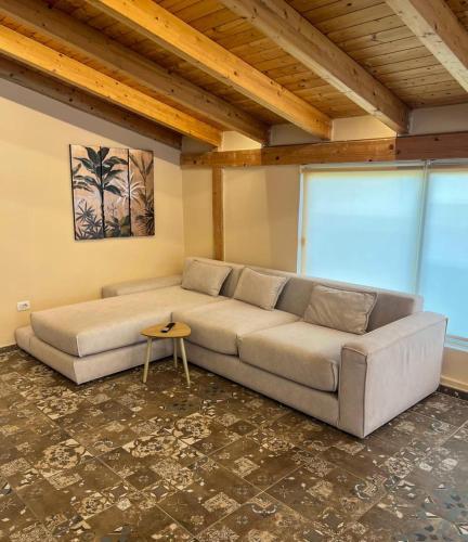 a living room with a couch and a table at Sea View Penthouse in Durrës