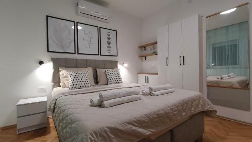 a bedroom with a large bed with pillows on it at The House Apartments & Guest Rooms in Ohrid