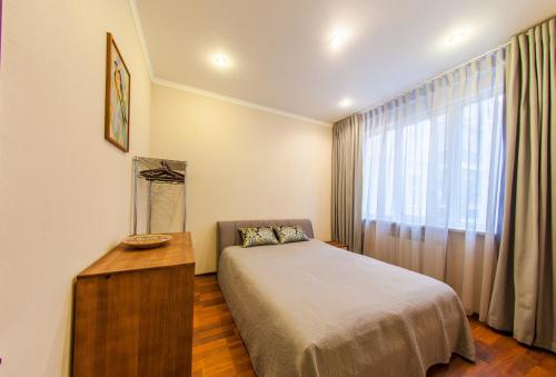 a small bedroom with a bed and a window at Botanic Towers the house has a shelter in Kyiv