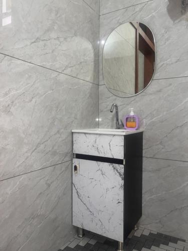 a bathroom with a sink and a mirror at Peace The Green Heaven in Jaipur