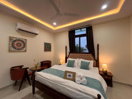 a bedroom with a large bed and a window at Peace The Green Heaven in Jaipur