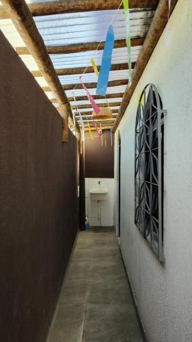 a hallway with a room with a ceiling with lights at Funcional, cômoda e confortável in Camaçari