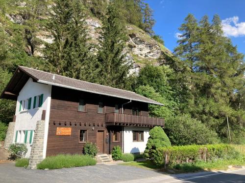 a small building with a mountain in the background at Chalet 12 Cerfs in Evolène
