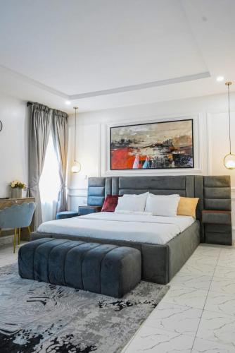 a large bedroom with two beds and a couch at Clarence House in Ikeja