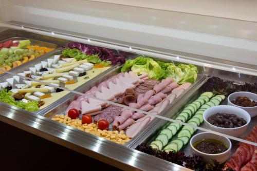 a refrigerator filled with lots of different types of food at Athens Avenue Hotel in Athens