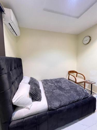 a bed in a room with a black couch at Studio apartment in Surulere in Lagos