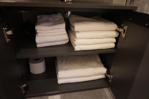 a closet with white towels on a shelf at Ludwig9 in Bayreuth