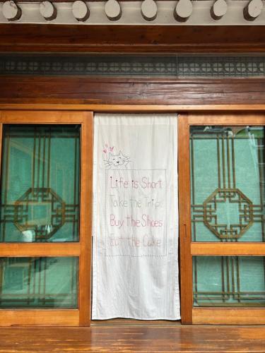 a sign on the window of a building at Hanok Guesthouse Suni in Seoul