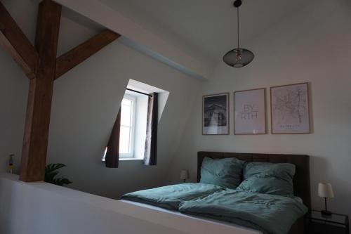 a bedroom with a bed with a cross on the wall at Ludwig9 in Bayreuth