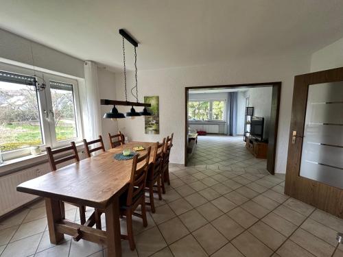 a kitchen and dining room with a wooden table and chairs at Ferienwohnungen Hoheeifel Nähe Nürburgring Platz für bis zu 10 Personen ,Verleih von zwei E-MTB möglich in Kelberg