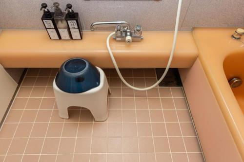 a toy dog bowl sitting under a bathroom sink at Irest Village Matsumoto in Matsumoto
