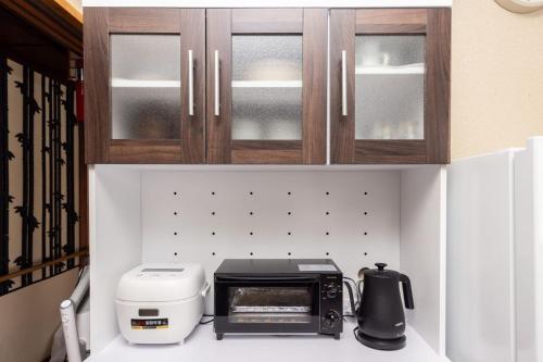 a kitchen with a counter with a toaster and a printer at Irest Village Matsumoto in Matsumoto