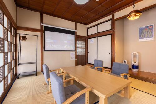 a conference room with a wooden table and chairs at Irest Village Matsumoto in Matsumoto