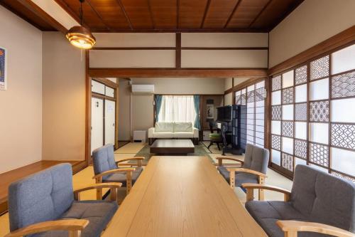 a conference room with a long table and chairs at Irest Village Matsumoto in Matsumoto
