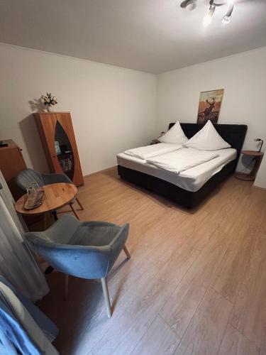 a bedroom with a bed and a table and a chair at Fagererhof in Bad Reichenhall