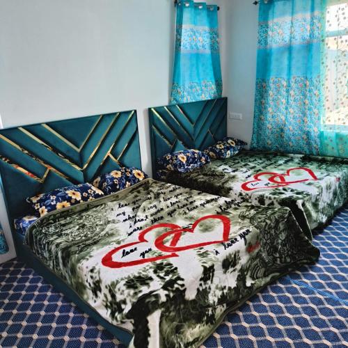 two beds in a room with hearts on them at Supreme Lake in Srinagar