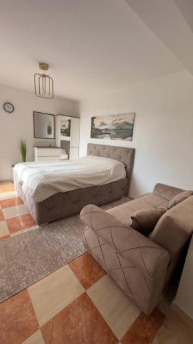 a bedroom with a bed and a couch at GreenHouse in Brca