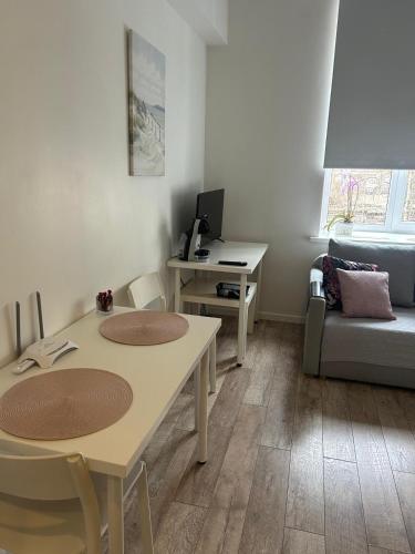 a living room with a table and a couch at Northern Lights small apartment A at Emmas Street 28, Riga in Riga