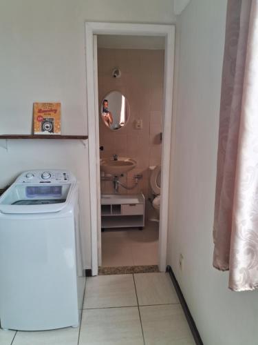 a small bathroom with a sink and a washing machine at Studio Playcenter in Campos dos Goytacazes