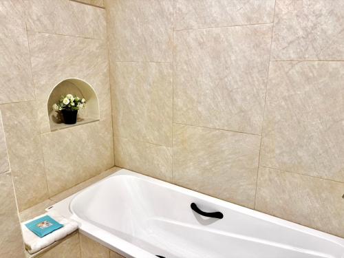 a bathroom with a bath tub in a room at Sunvada Beach Rayong in Rayong