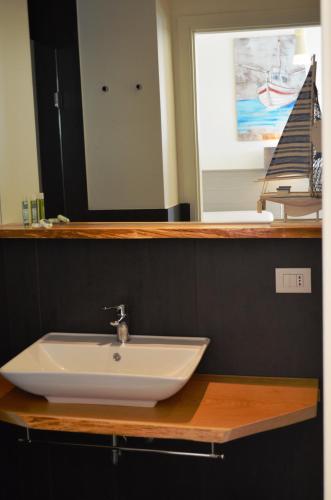a bathroom with a white sink and a mirror at Appartamenti Barzilai in Gabicce Mare