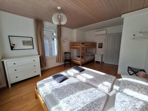 a bedroom with two beds and a wooden ceiling at Interlaken Central 1 in Interlaken