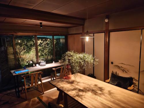 a room with a wooden table and a window at Walkable retro town , Supermarkets nearby,高野口ガッコーチカクのゲストハウス in Hashimoto